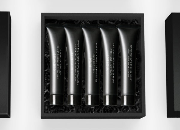 black skin care sample tubes in a shipping box