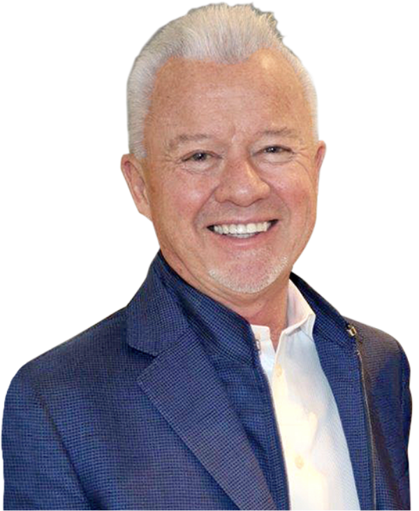 smiling man with white hair and a modern blue suit