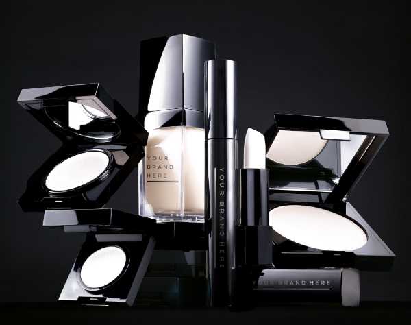 makeup sample kit with glossy black cases and cream coloured makeup